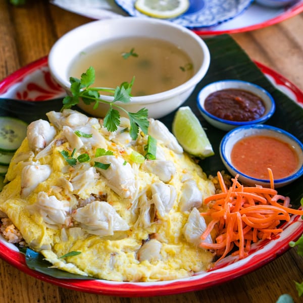 Daughter Thai Kitchen's crab fried rice with omelet, soup, sauces, lime, and shredded carrots.